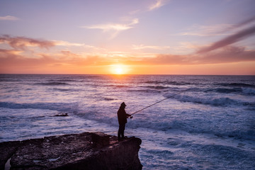 Silhouette of a fisherman to fish in the ocean, Portugal