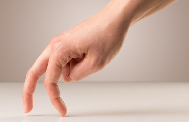 Female fingers walking on white surface