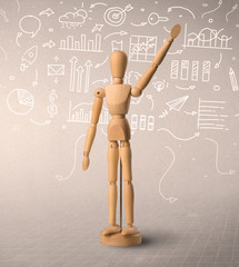 Wooden mannequin posed in front of a greyish background with white scribbled data around him