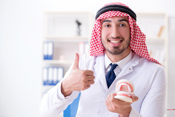 Arab dentist working on new teeth implant