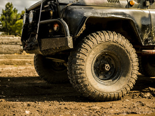 Fototapeta premium close up off road suv truck vehicle on the dirty landscape mountain
