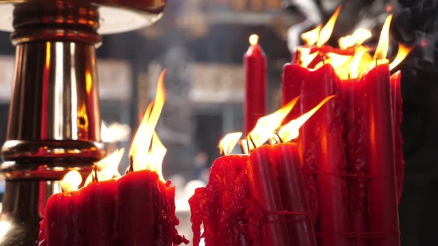 Religious red candle fire burning dancing in the wind in Longshan Temple, Taiwan Taipei