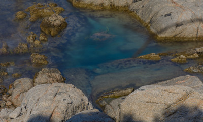 Rocks surrounding emerald water
