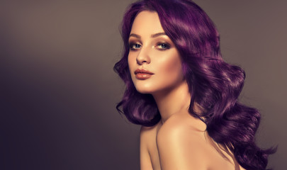 Beautiful model girl with long purple curly hair . Care products ,hair colouring .  Treatment, care and spa procedures. Medium length hairstyle. Coloring, ombre,  and highlighting . Hair coloring  