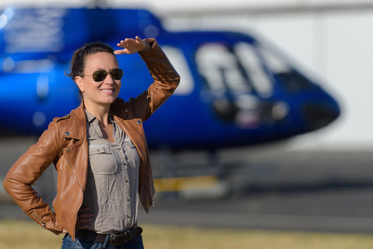 smiling woman near an helicopter