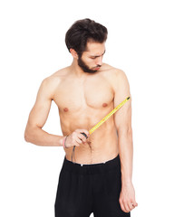 Young man with beard worker with tape measure in hand without shirt on white isolated background