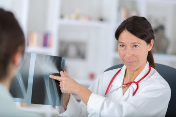 female dentist showing x-rays to patient