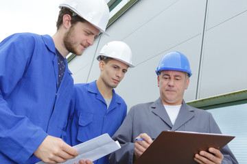 students engineers examining construction site outdoors