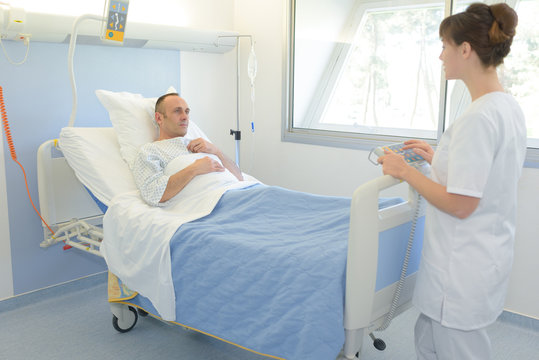 nurse visiting patient in his hospital room
