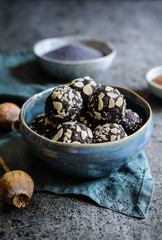 Raw poppy seeds balls covered with almond flakes