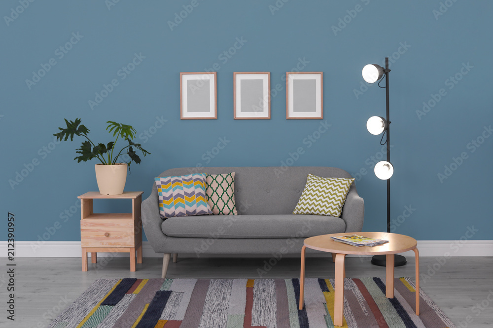 Poster stylish living room interior with comfortable sofa