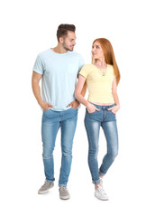 Young couple in stylish jeans on white background