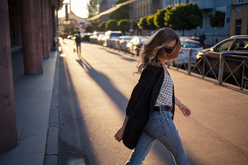 Fototapeta premium Happy young girl walking around town, portrait on the city background.