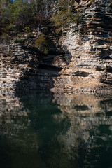 An odd rock formation reflected in a body of water