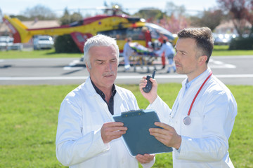mature doctors outside responding to an emergency