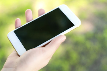 Young women's hands holding smartphone.
