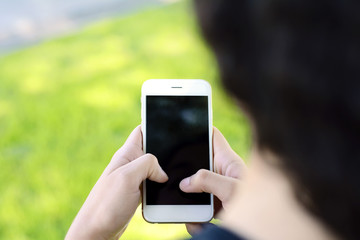 Young latin women sending message with smartphone.