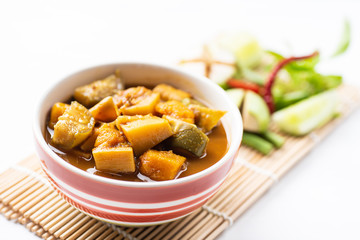 Fish organs sour soup (Kaeng Tai Pla) in a bowl and vegetables, Southern Thai food