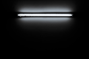 Detail of a fluorescent light tube mounted on a wall