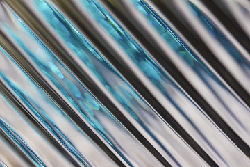 Metallic looking macro abstract background featuring defocused lead crystal glass with diagonal...