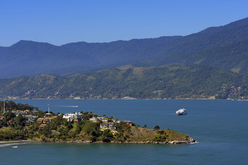 Fototapeta na wymiar Landscape with blue hills, sea and boat