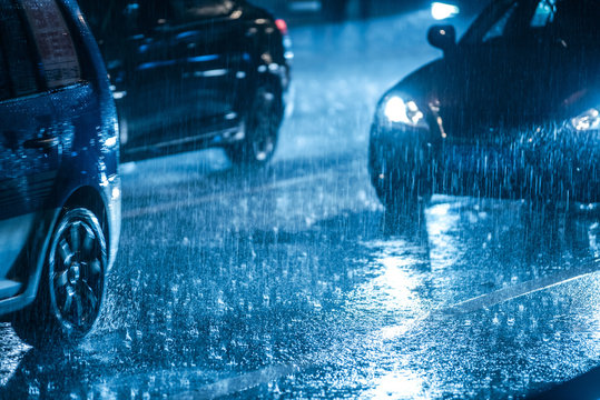 Cars driving on wet road in the rain with headlights © Bob