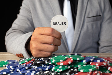 Businessman holding deaker coin isolated on black. Casino and Broker concept.