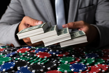 Businessman holding a lot maney on desk. Casino and Broker concept.