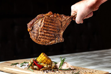 A large roasted piece of mutton steak, pork, veal or beef on bones cooked on an air fryer, in the...