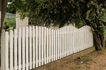 White wooden fence along the private courtyard.