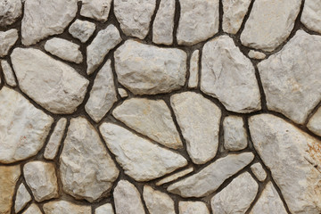 Wall of rough marble stones