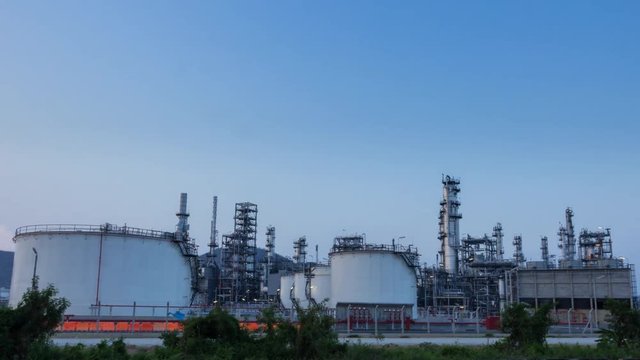 Time lapse of oil refinery industry at sunset, day to night