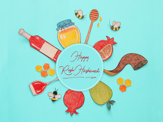Rosh hashanah (jewish New Year holiday) concept. Traditional symbols shapes cut from paper and painted.