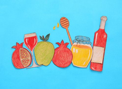 Rosh hashanah (jewish New Year holiday) concept. Traditional symbols shapes cut from paper and painted.