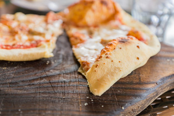 close up of pepperoni pizza on wooden desk, selective focus