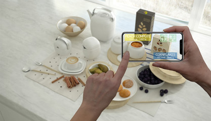 Augmented reality concept. Hand holding digital tablet smart phone use AR application to check...
