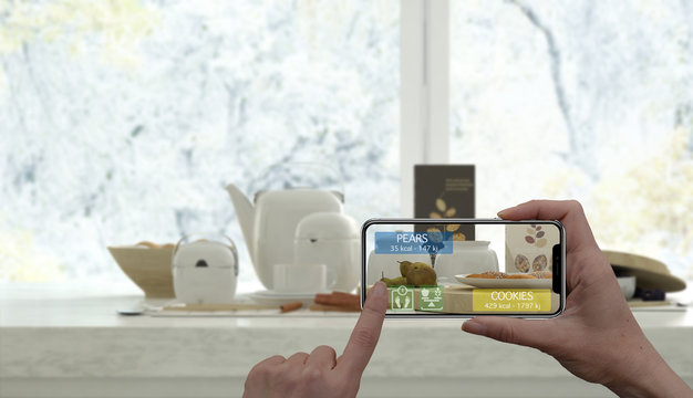 Augmented reality concept. Hand holding digital tablet smart phone use AR application to check information of calories in healthy breakfast