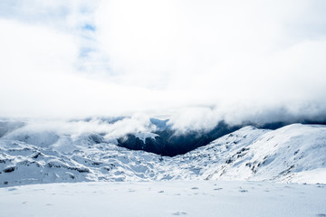 The stunning landscape of the snowy mountain on a foggy misty cloudy day. Kahurangi national park, New Zealand.