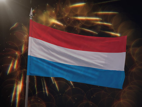 Flag of Luxembourg with fireworks display in the background