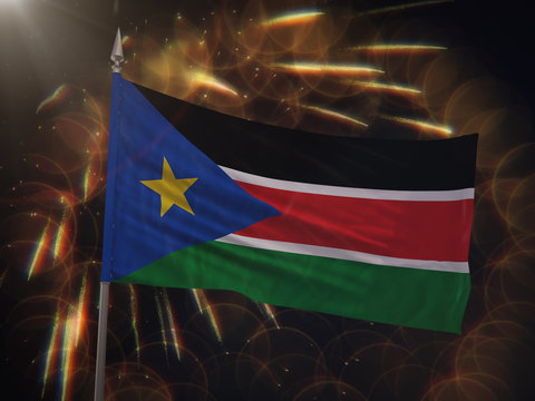 Flag of South Sudan with fireworks display in the background