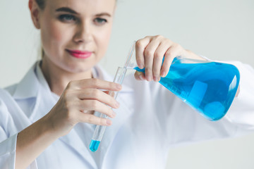 Female scientist using test tube