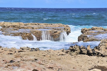 Beach area with a rocky shoreline and waves breaking