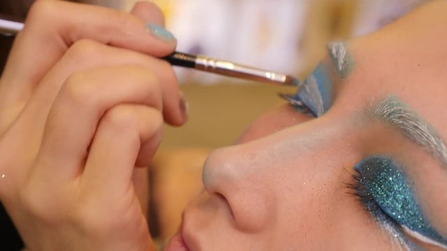 CLOSE UP Unusual Make Up Blue Eyebrows Teen Apply Glue On Eyelids For Glitter