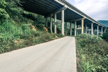 highway bridge through green hills