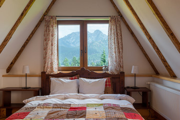 a window in a palm on the top floor of a rural house with a beautiful view of the mountains