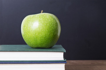 concept of back to school with apple tree, books and blackboard