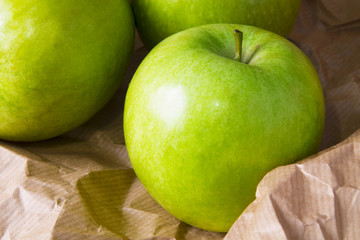 green apples on brown packing paper