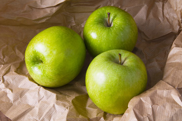 green apples on brown packing paper