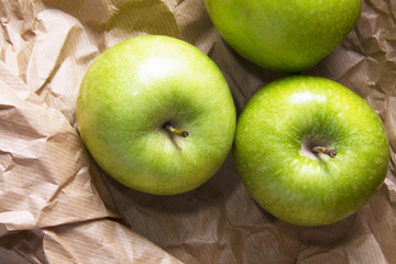 green apples on brown packing paper