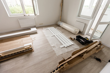 Assembling wooden bed in room